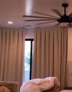 Somfy motorized blackout roller shades fully closed on large living room windows and glass doors in Agoura Hills, providing complete privacy and light blocking.