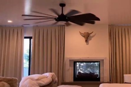 Electric custom roller shades partially open on stylish dining room glass doors, letting in natural light while maintaining a sleek, contemporary look in Agoura Hills.