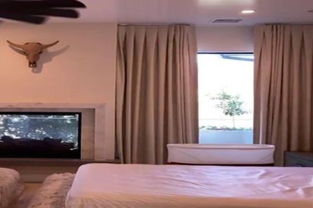 Close-up of Somfy motorized blackout roller shades in action, showing seamless integration with modern living and dining room decor and automated window coverings.